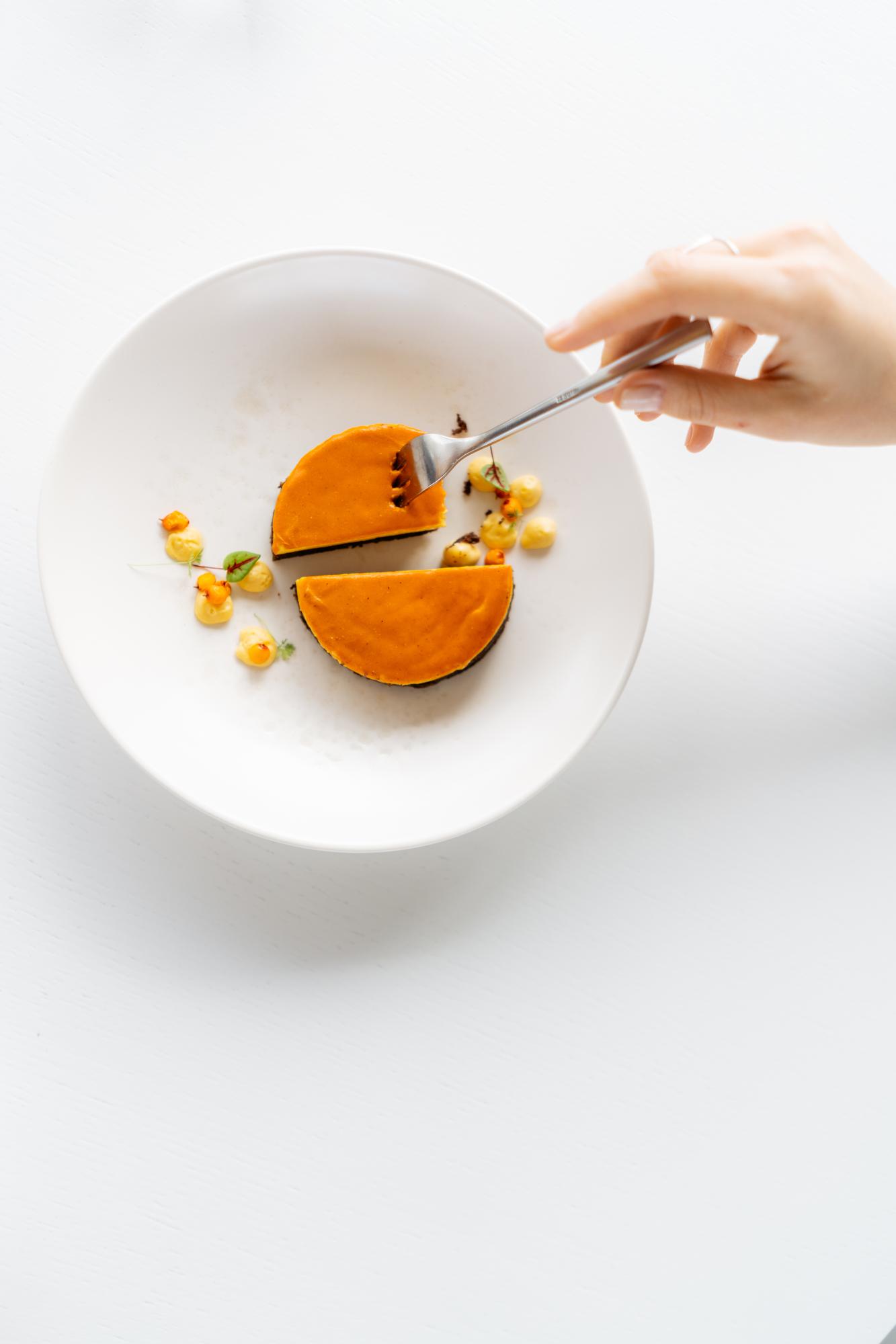 Chef plating a colorful modern dish on ceramic plate